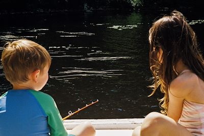 Enfants pêchant le long d'une rivière